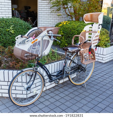 TOKYO, JAPAN - NOVEMBER 23: Bicycle with baby seat in Tokyo, Japan on November 23, 2013. The bicycle with baby seats that can carry children is very popular among  parents in many cities in japan