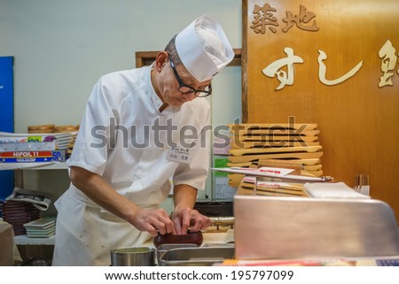TOKYO, JAPAN - NOVEMBER 25: Japanese Sushi Chef  in Tokyo, Japan on November 25, 2013. Unidentified Japanese Sushi Chef prepares a dish of sushi for his customer