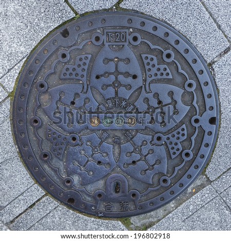 TOKYO, JAPAN - NOVEMBER 24:  Manhole cover in Tokyo, Japan on November 24, 2013. Ginkgo leaves with sakura flower on a manhole, they are symbol of Chuo ward in Ningyocho area