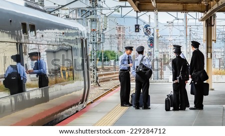 KYOTO, JAPAN - OCTOBER 20: Japanese Train Conductors in Kyoto, Japan on October 20, 2014.  Unidentified group of off duty Japanese train conductors gather in a platform at Kyoto Station