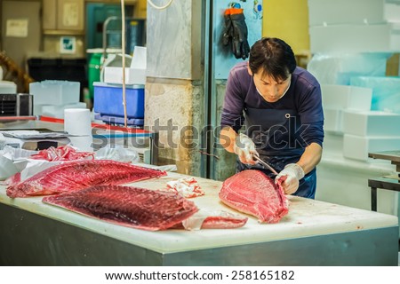 OSAKA, JAPAN - OCTOBER 24: Osaka Central Wholesale Market in Osaka, Japan on October 24, 2014. Unidentified japanese fish seller cut the tuna in sizes before selling to customers