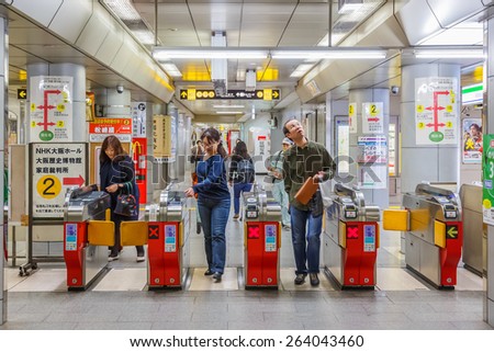 OSAKA, JAPAN - OCTOBER 25: Subway Commuter in Osaka, Japan on October 25, 2014. Unidentified people enter the ticket gate for subway train at a subway station