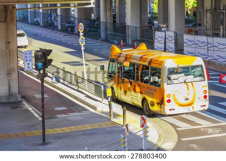 OSAKA, JAPAN - OCTOBER 28: Japanese School Bus in Osaka, Japan on October 28, 2014. A cute design Japanese schoolbus on the way the send students back from school