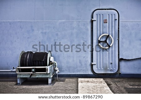 A Security Door and a Hose on an Aircraft Carrier