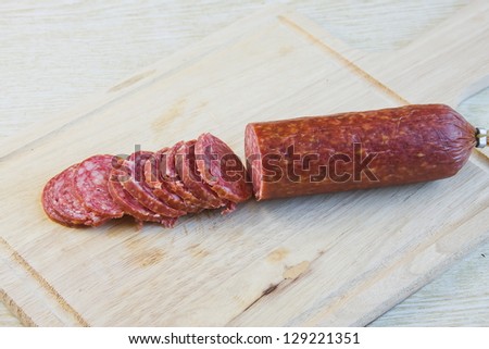 long loaf the smoked sausage on a wooden surface