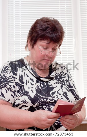 woman middle-aged with a foreign passport in hands
