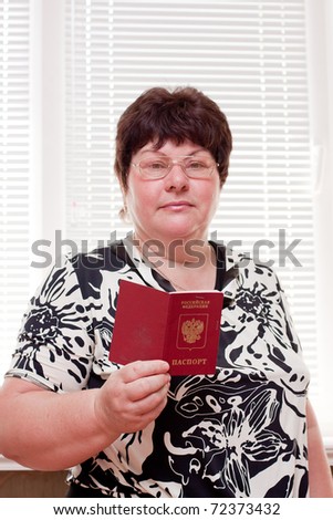 woman middle-aged with a foreign passport in hands