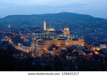 Buda Castle, Matthias Church and the Castle District with the hills of Buda in the background, in floodlight. Buda Castle is the historical castle complex of the Hungarian kings in Budapest, Hungary.
