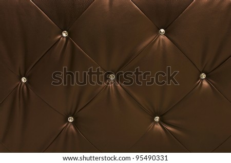 brown leather upholstery with crystals, textured background