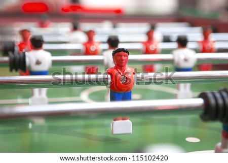 Table football table, football players and red rice wine.