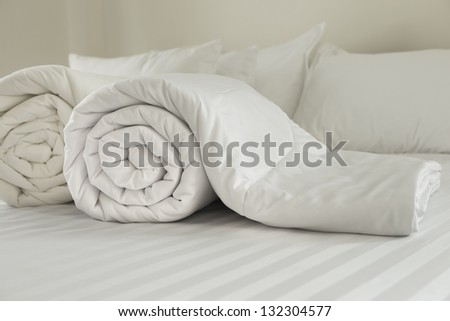 Duvet roll.  down filled duvet rolled up isolated on white background