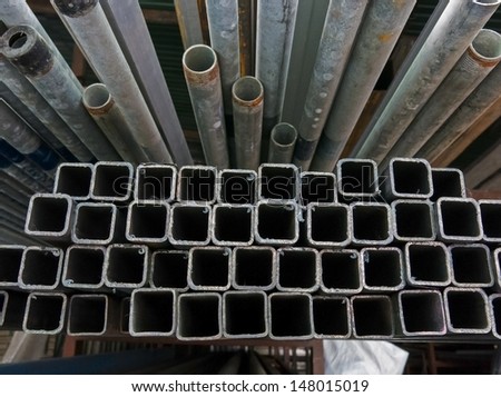 A series of different sizes metal pipes on shelf Metal pipe stack on shelf