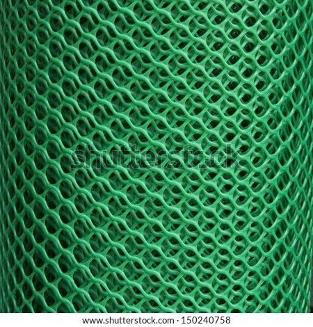 Coated green metallic wire mesh used in gardening by protecting plants from animals.