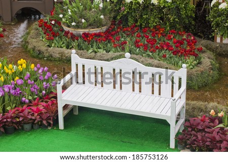 White tulips in a garden chair.