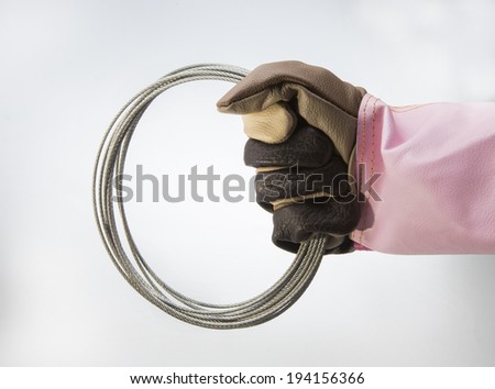 working hand in glove holding wire