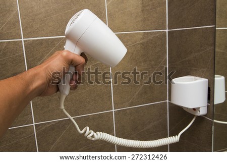 White Hair Dryer on wall in bathroom