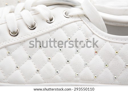 Pair of new white sneakers on white background