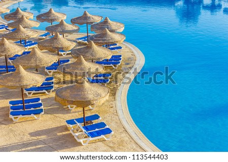 The view from the window of the hotel in Egypt to the pool, sun umbrellas and the Red Sea
