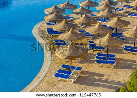 The view from the window of the hotel in Egypt to the pool, sun umbrellas and the Red Sea