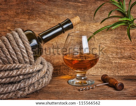 bottle of wine wrapped with rope on the background of the old wooden planks