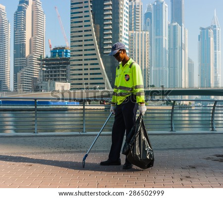 DUBAI, UAE - NOVEMBER 13, 2012: Dubai street cleaner