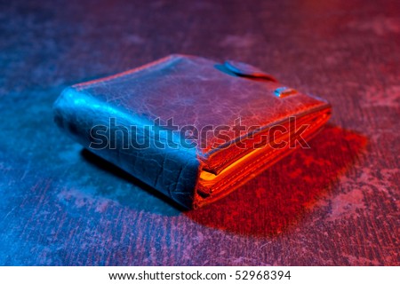 Leather purse on the table in a color light