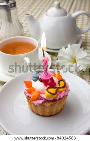 cake with a candle and tea drinking