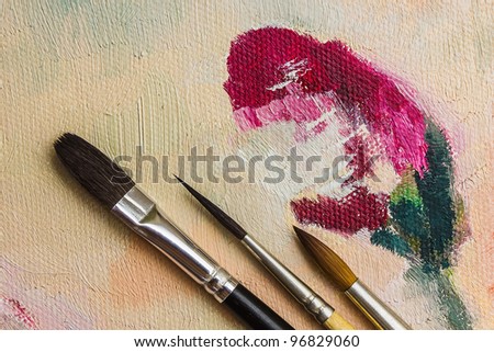 colored paints and brushes for painting on canvas and paper
