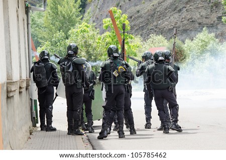 CIÑERA, SPAIN - JUNE 19:  Anti riot police agents of the Guardia Civil disperse striking miners shooting rubber balls and smoke cans on June 19th 2012 in Ciñera, Spain.