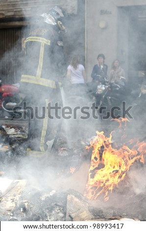 BARCELONA, SPAIN - MARCH 29: One of the multiple fires caused by heavy riots during nationwide spanish general strike against labour reforms in the city center of Barcelona on March 29, 2912.