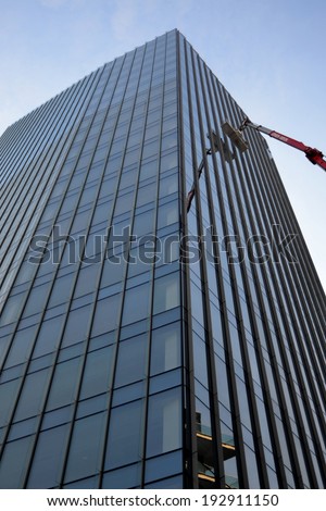 MILAN,ITALY-DECEMBER 5: worker who cleans the windows in a skyscraper on December 5, 2013 in Milan Italy