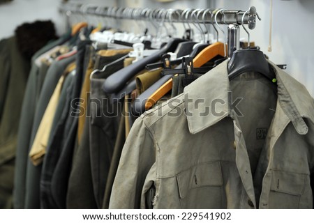 MILAN, ITALY - NOV 1: Military jackets, Exhibitor sitting in his stand at Militalia, exhibition dedicated to militaria collectors and military associations on November 1, 2014 in Milan.