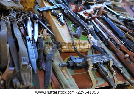 MILAN, ITALY - NOV 1: Weaponry, Exhibitor sitting in his stand at Militalia, exhibition dedicated to militaria collectors and military associations on November 1, 2014 in Milan.