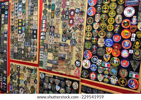 MILAN, ITALY - NOV 1: Military patches, Exhibitor sitting in his stand at Militalia, exhibition dedicated to militaria collectors and military associations on November 1, 2014 in Milan.