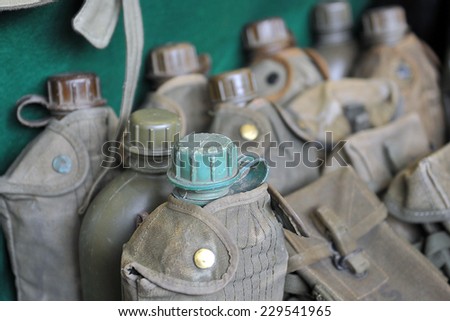 MILAN, ITALY - NOV 1:Old bottles,  Exhibitor sitting in his stand at Militalia, exhibition dedicated to militaria collectors and military associations on November 1, 2014 in Milan.