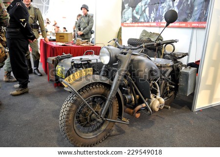 MILAN, ITALY - NOV 1: Old motorcycle military, Exhibitor sitting in his stand at Militalia, exhibition dedicated to militaria collectors and military associations on November 1, 2014 in Milan.
