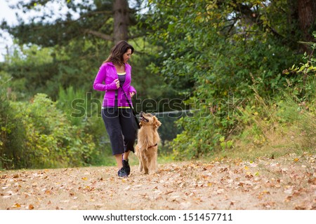 A Pretty Woman Walking Her Dog