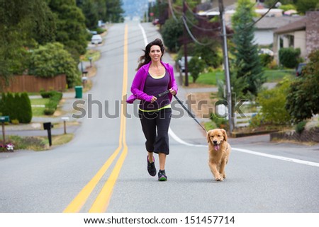 Golden Retriever dog running with a pretty woman