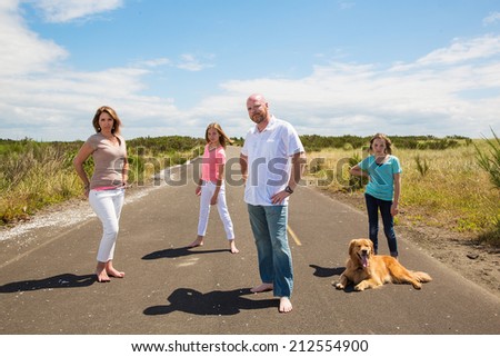 Family poses for a photo on a quiet road in the country