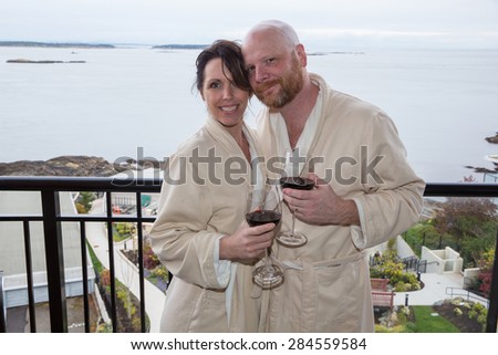A happy couple on vacation with wine and a view