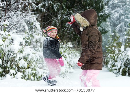 two kids having a snow ball fight