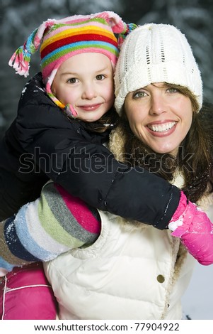 Mother and Daughter playing outside in the snow