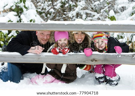 A happy, healthy family outside in the snow.