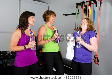 woman drinking water at a gym