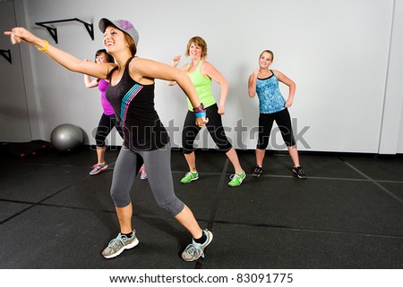 An aerobics and dance class for women at a gym.