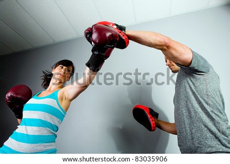 Man and Woman training to box in a gym