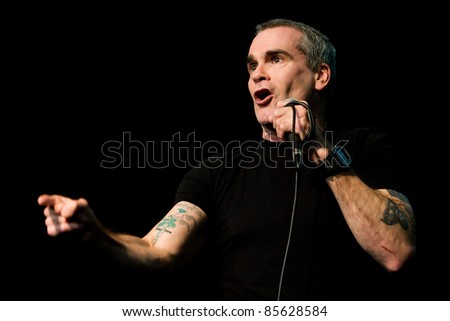 SEATTLE - APRIL 6:  Spoken word artist, rock star, singer, movie star, actor, poet, activist Henry Rollins speaks on stage at the Triple Door Theater in Seattle, WA on April 6, 2011.