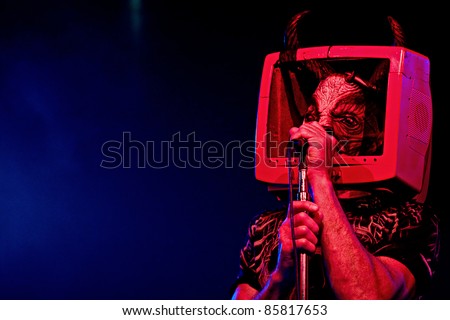 SEATTLE - JULY 1:  Fee Waybill of classic rock band the Tubes dressed in a devil costume with his head in a TV performs on stage at the Triple Door Theater in Seattle on July 1, 2011.