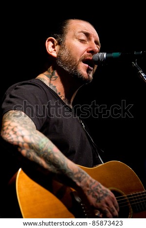 SEATTLE - FEB 13:  Mike Ness of rock band Social Distortion sings and plays guitar on stage at the Crocodile in Seattle on February 13, 2011.
