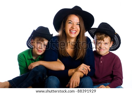A happy, country family with cowboy hats.  Cute boys and a pretty Mom.